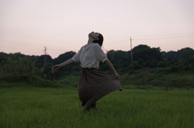 A serene landscape with a person stretching, symbolizing freedom of movement.
