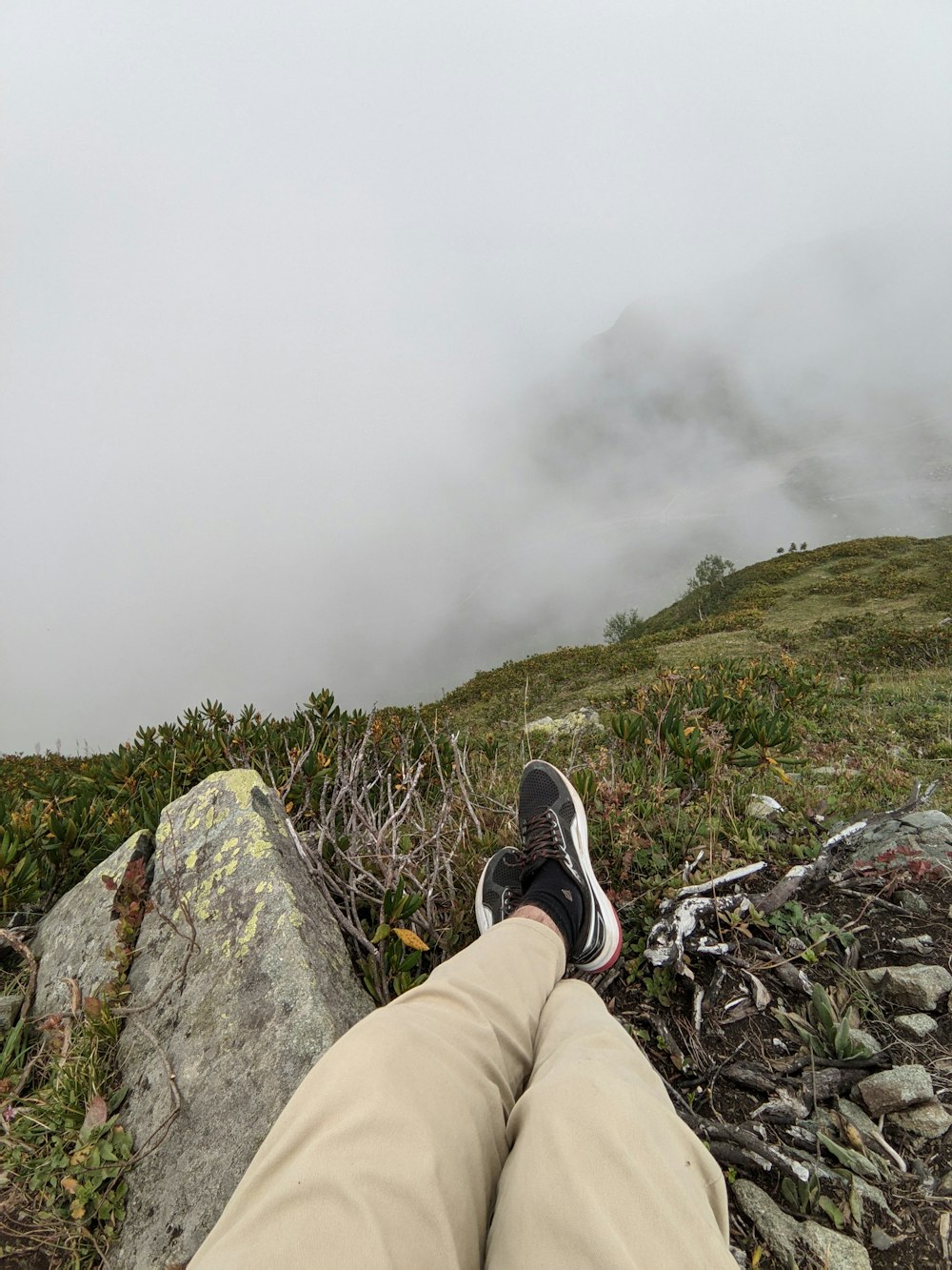 a person with their feet up on a rock