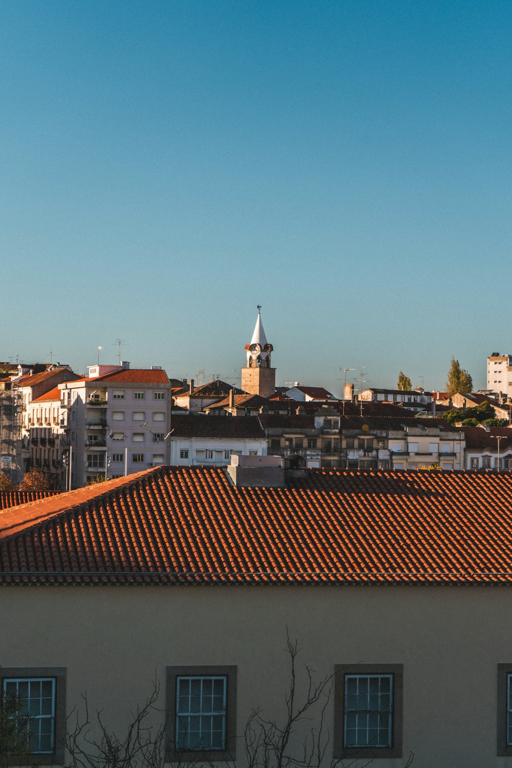 a view of a city with a clock tower in the distance