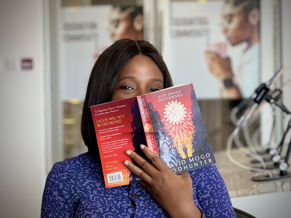 a woman holding two books in front of her face