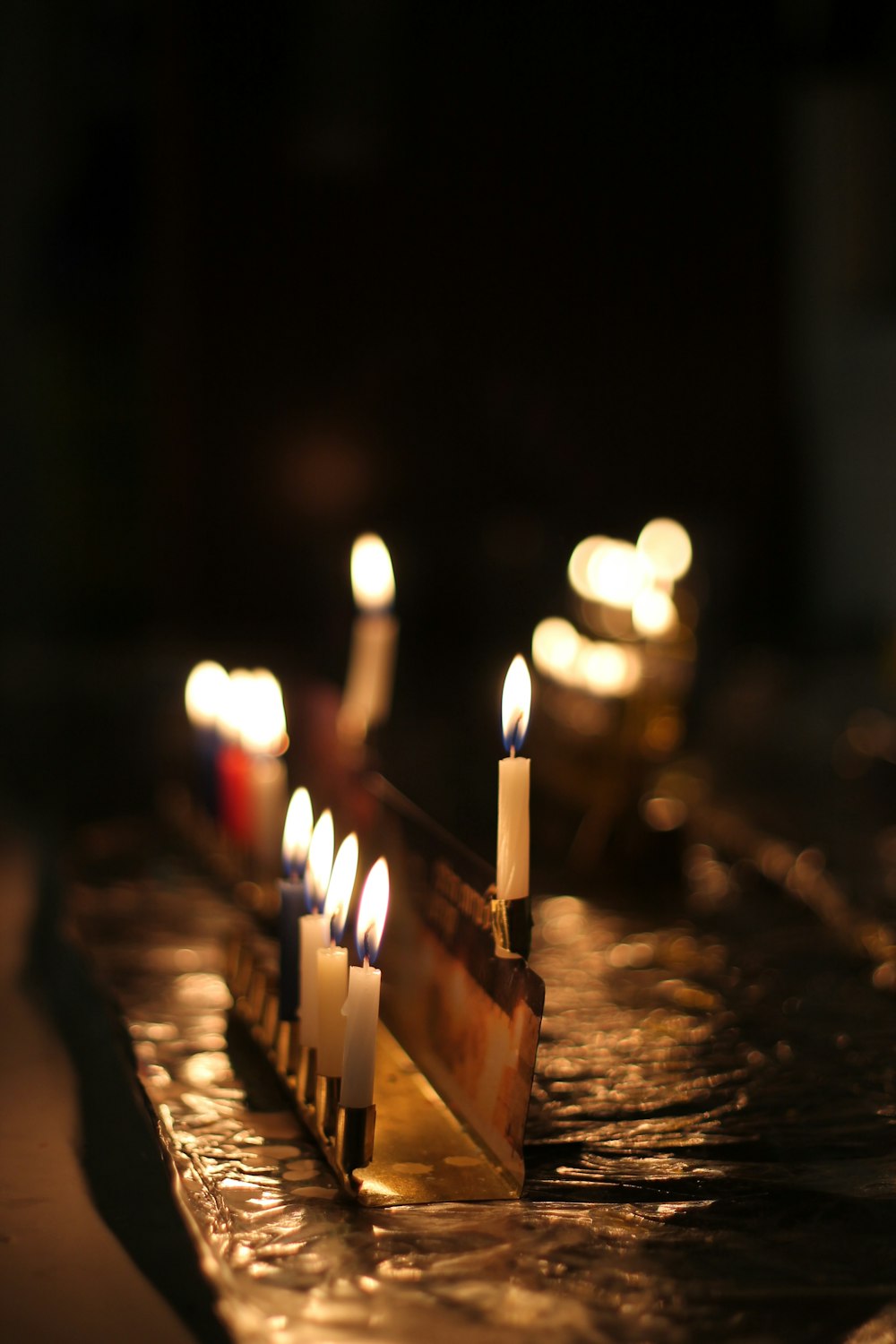 a group of lit candles sitting on top of a table