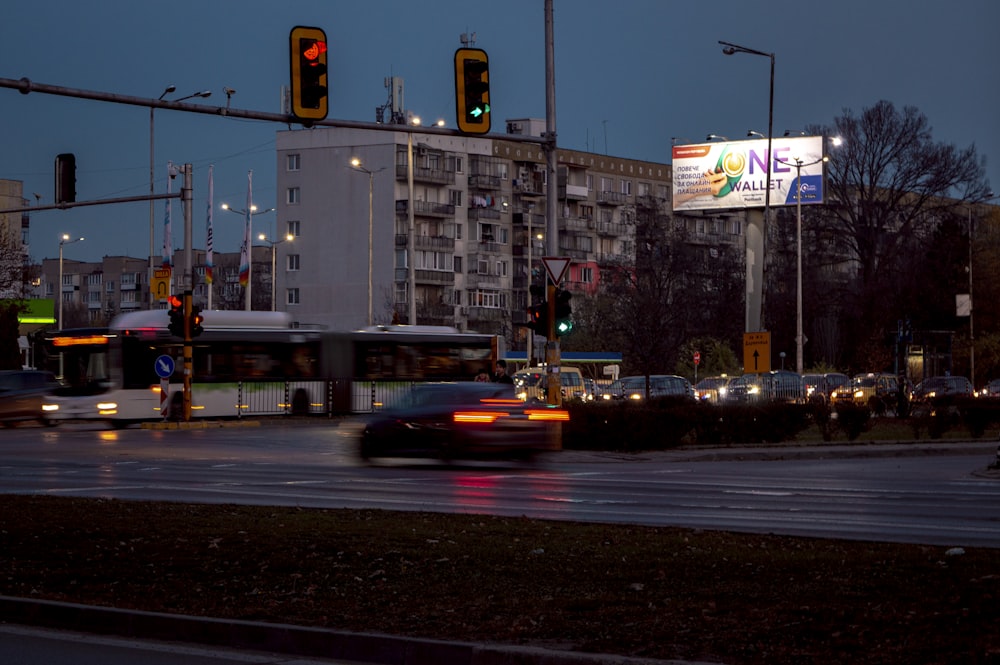 a city street at night with traffic lights