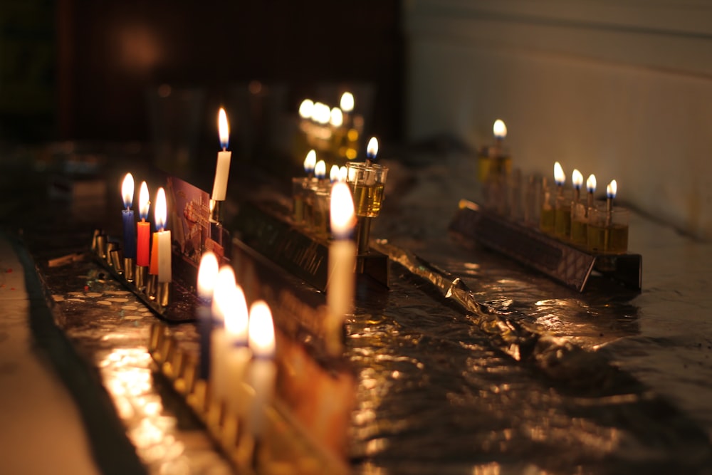 a group of lit candles sitting on top of a table