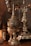 Intricate silver goblets and ornate metalware with detailed engravings and a reflective surface are displayed. The objects have a rich patina, suggesting age and craftsmanship.