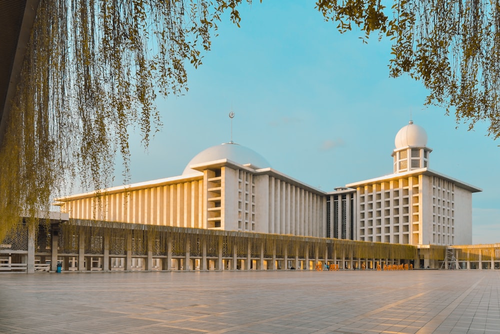 a large white building with two white domes on top of it