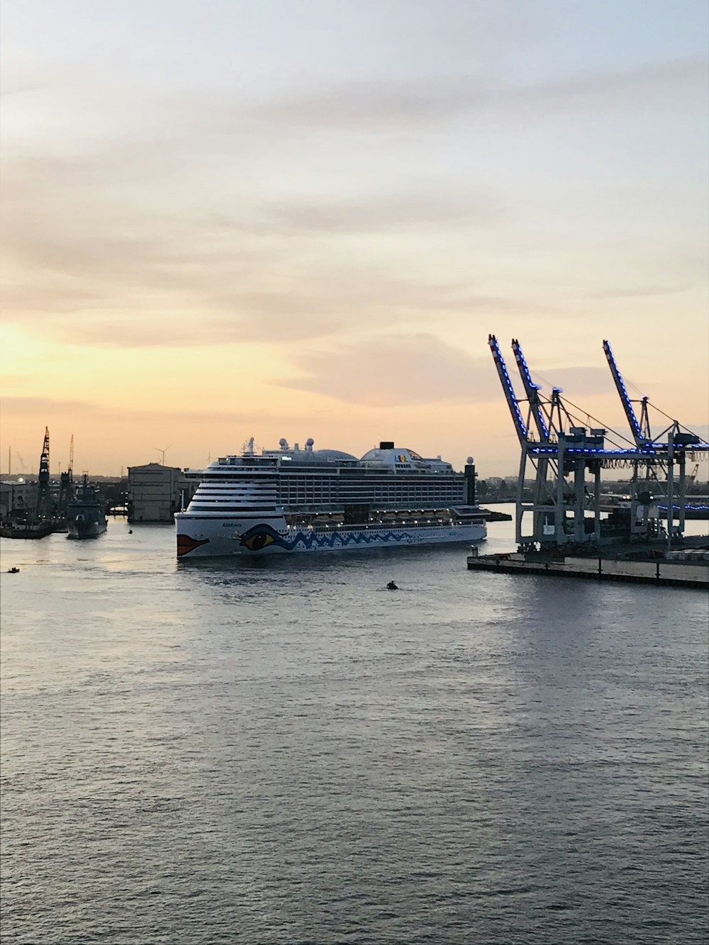 a large cruise ship in the water next to a dock