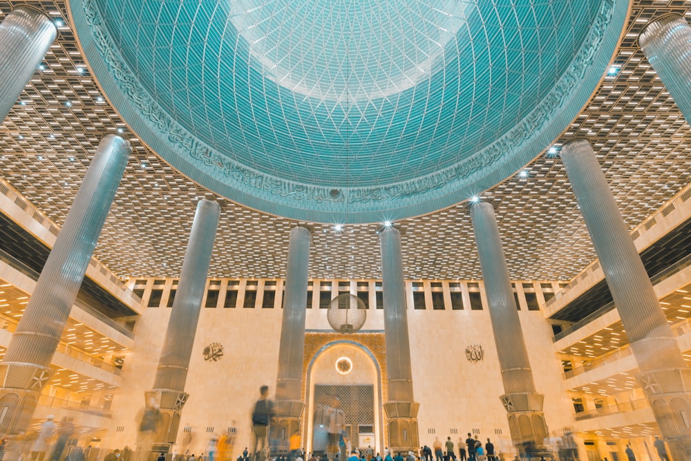 a group of people standing in a large building