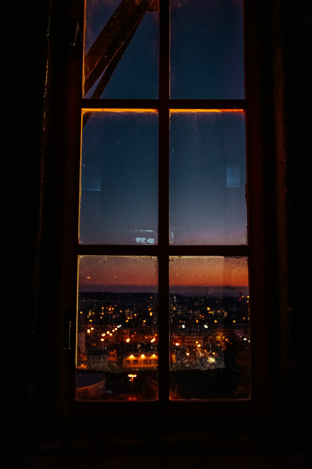 a window with a view of a city at night