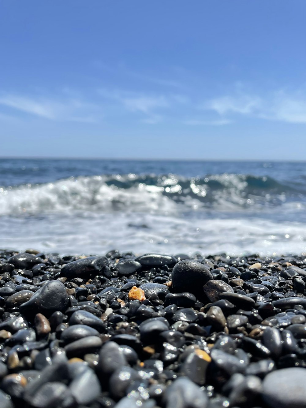 a close up of rocks on a beach near the ocean