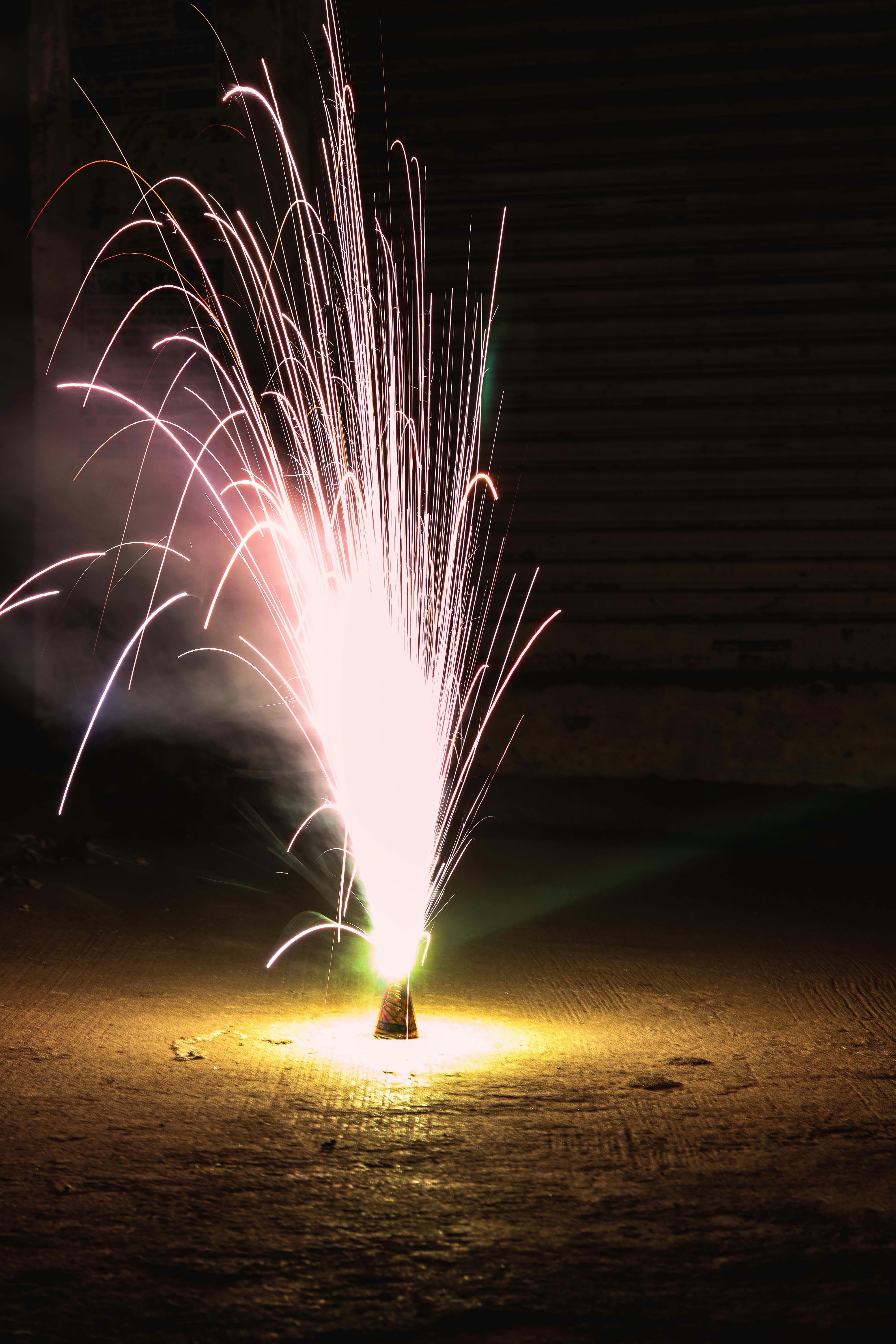 a colorful fireworks is lit up in the dark
