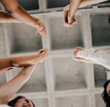 a group of people standing in a circle holding hands