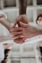 a group of people putting their hands together