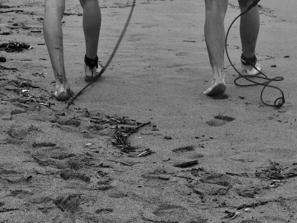 a person walking on a beach with a horse