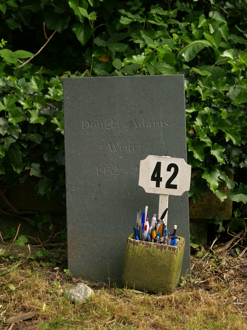 a memorial marker with pens and markers in it