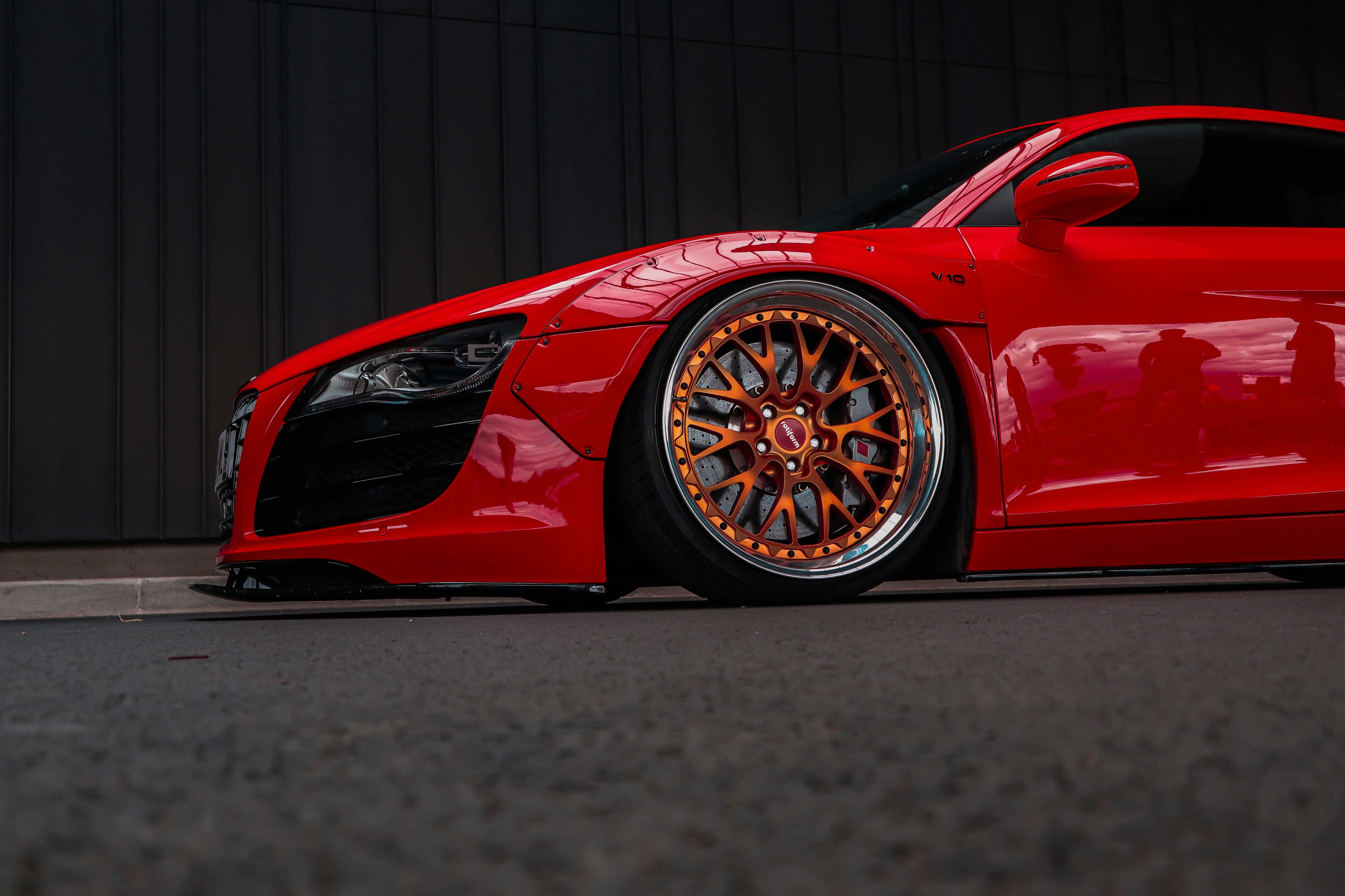 a red sports car parked in front of a building