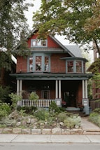 a red brick house with a large front porch