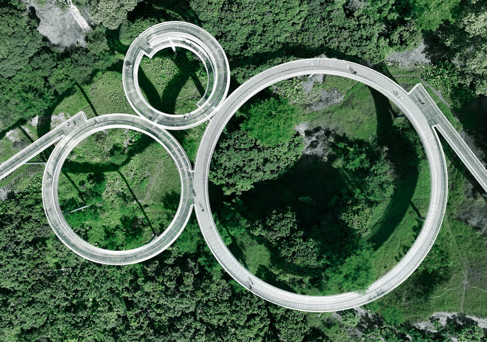 an aerial view of a winding road in the middle of a forest