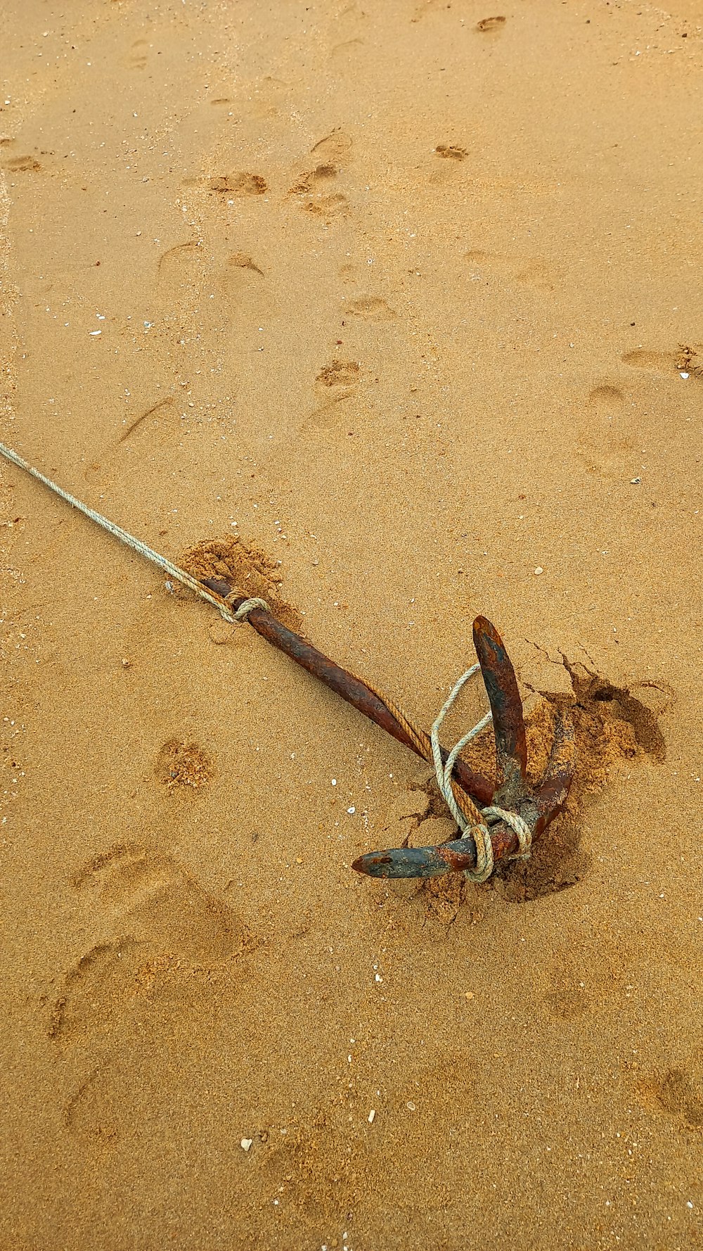 a broken umbrella laying on the sand on the beach