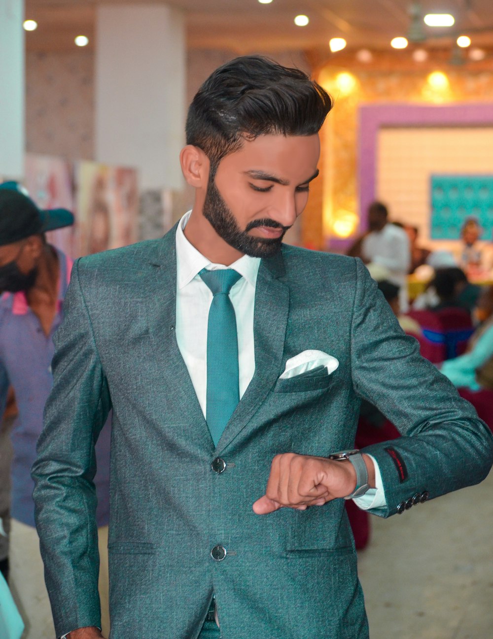 a man in a suit and tie looking at his watch