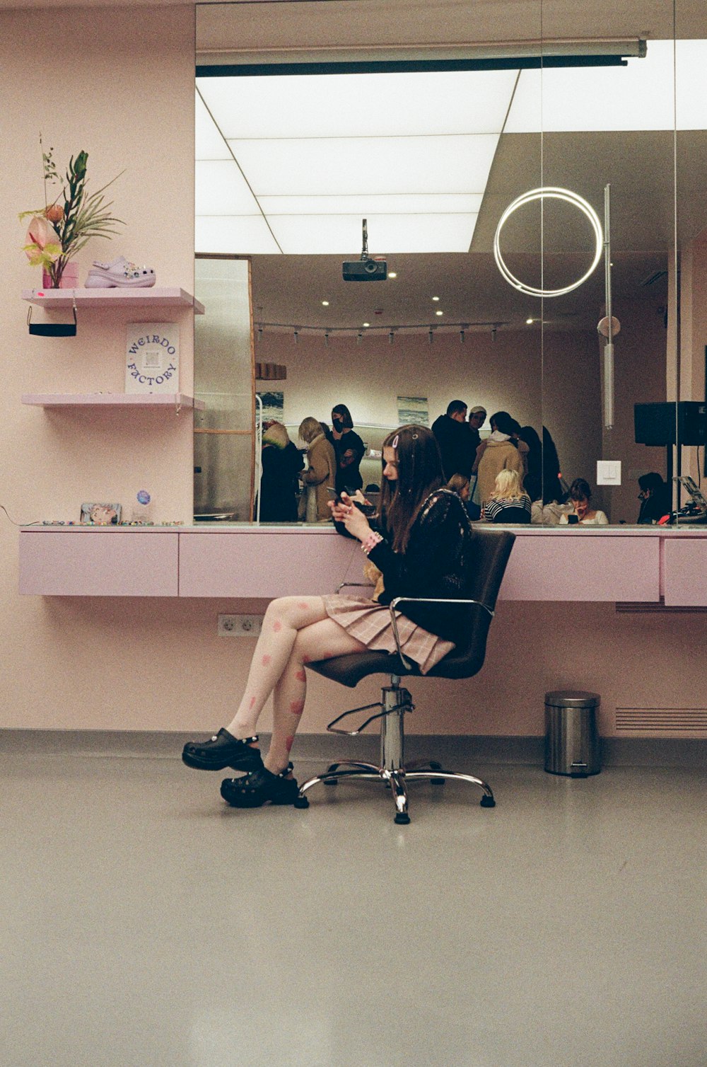 a woman sitting in a chair in front of a mirror