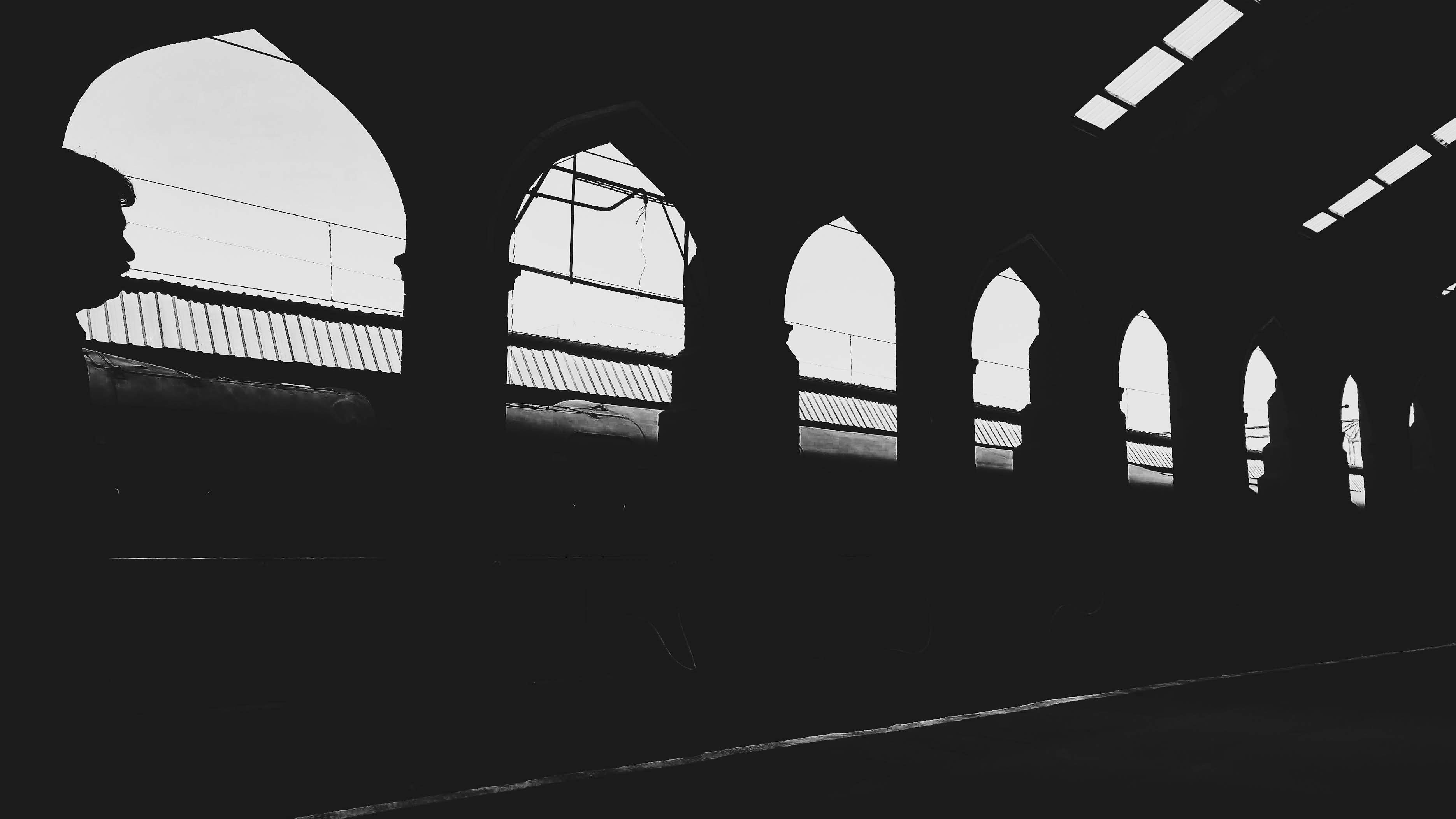 Black shadow silhouettes in train station