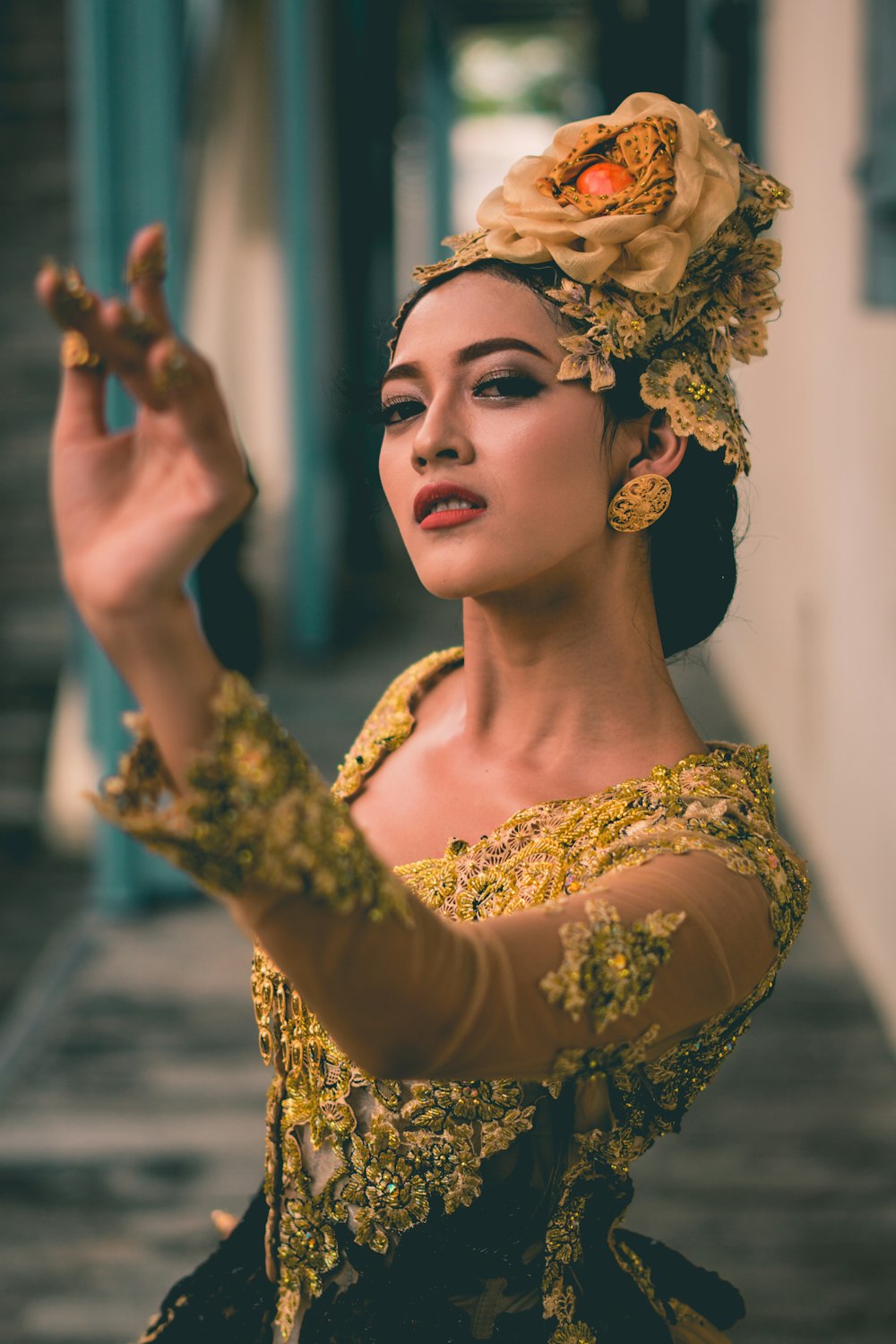 a woman wearing a yellow dress and a flower in her hair