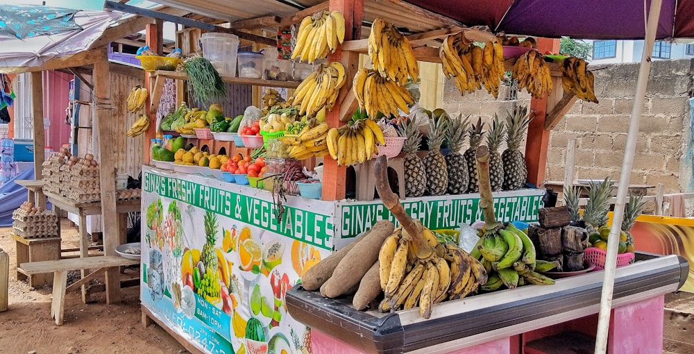 a fruit stand with bananas and other fruits