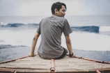 Close-up of a thoughtful man looking out over a calm ocean horizon.