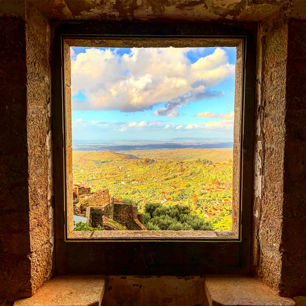 a window with a view of a valley