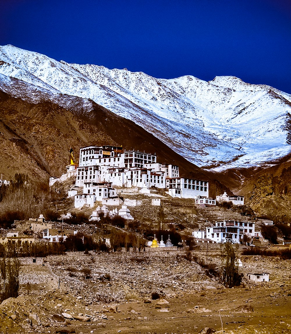 a large white building sitting on top of a snow covered mountain