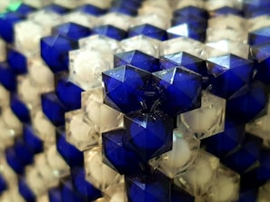 Close-up of shiny plastic pellets in a vibrant blue color, highlighting texture and quality.