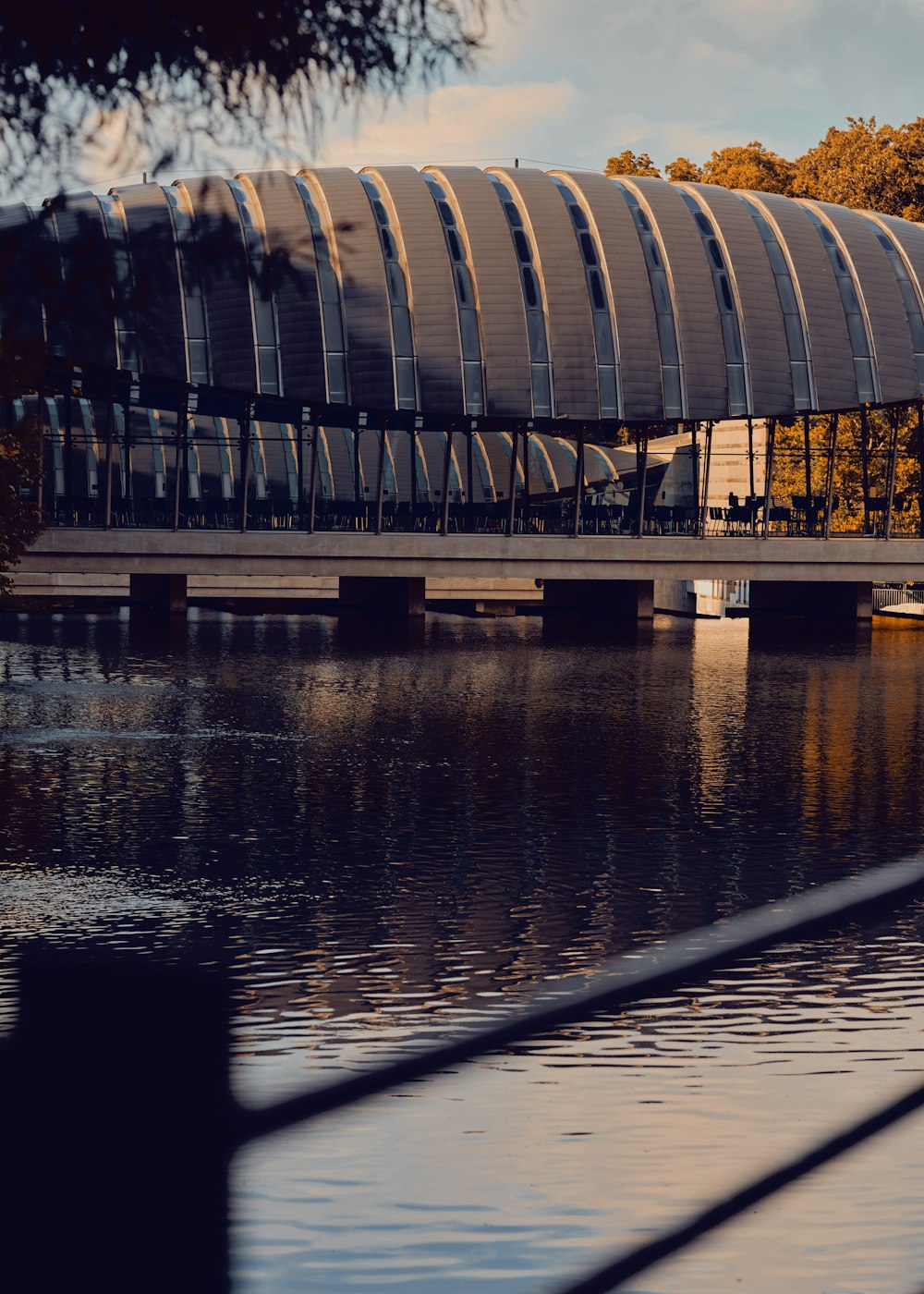 a bridge over a body of water with a building in the background