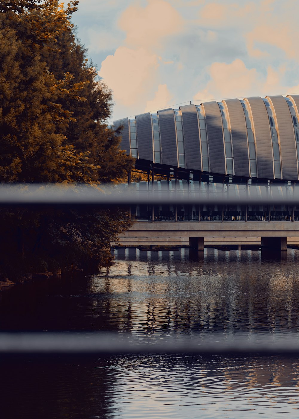 a bridge over a body of water with a building in the background