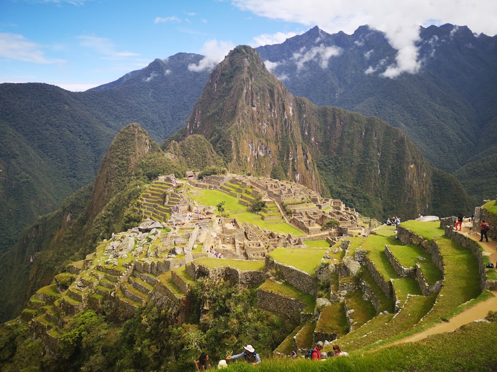 a group of people standing on the side of a mountain