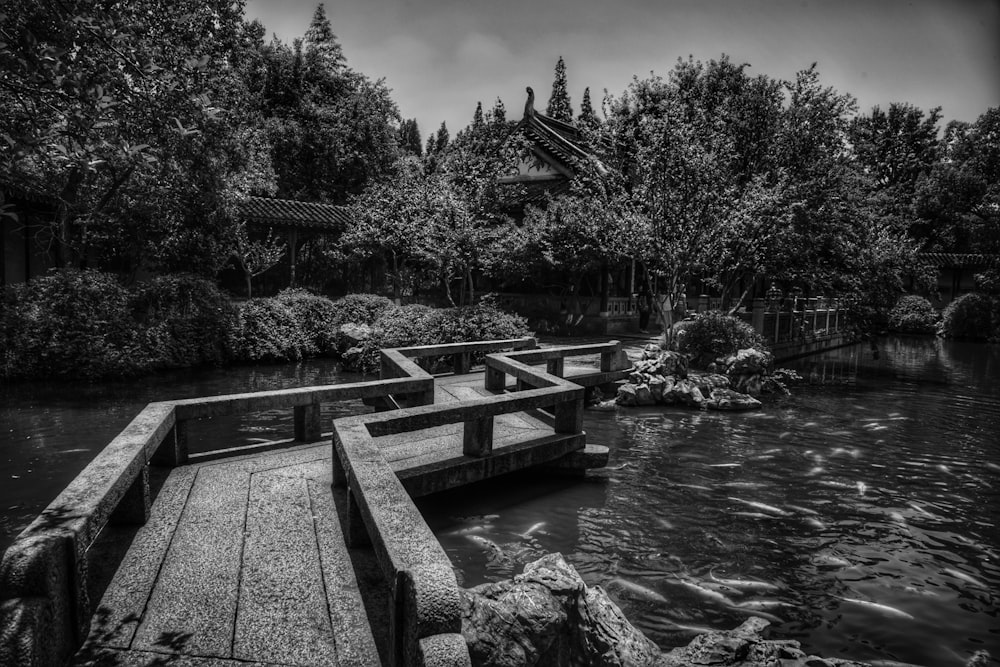 a black and white photo of a wooden bridge