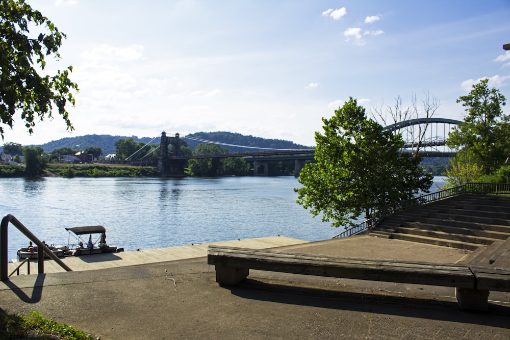 a bench sitting on the side of a river