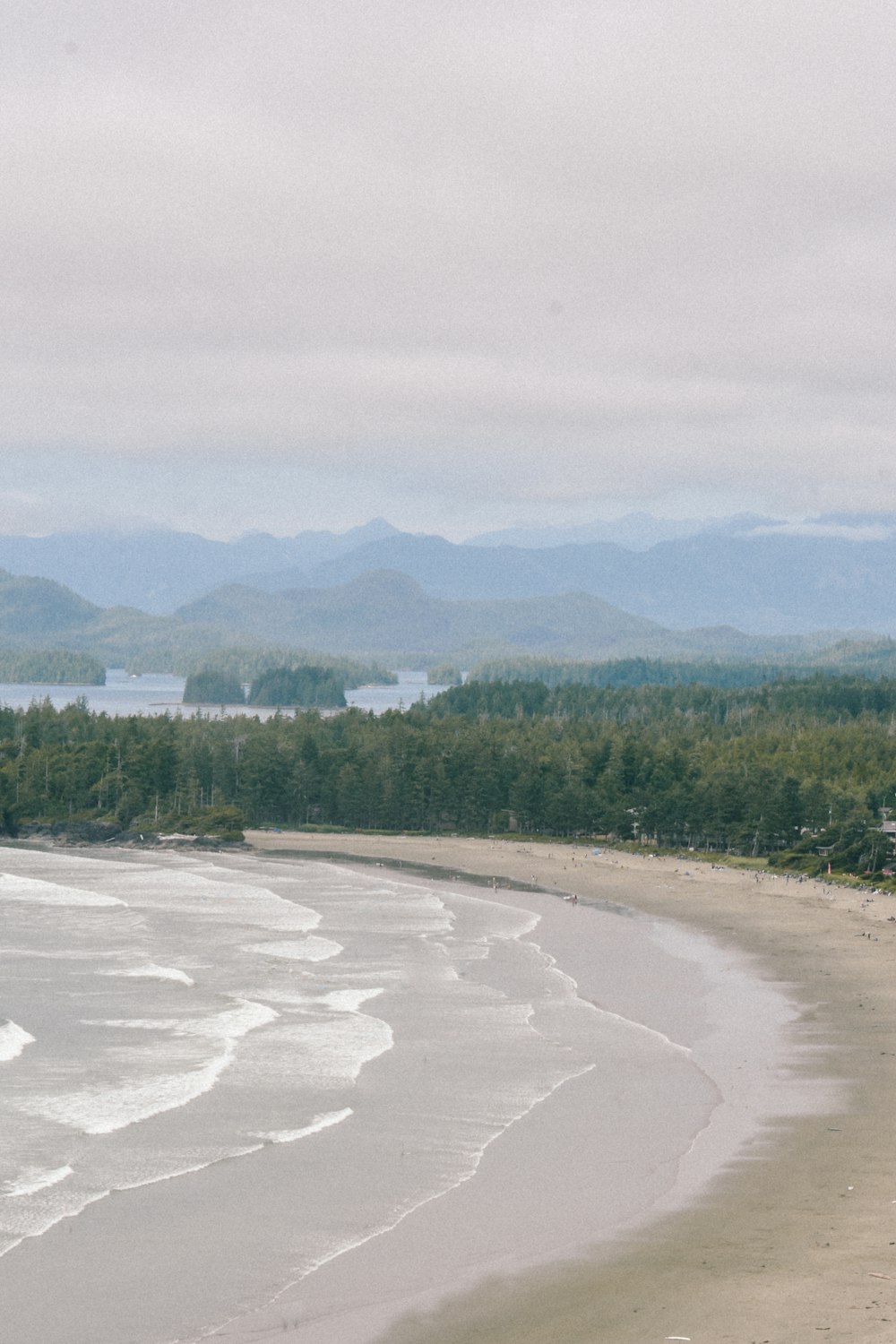 a view of a beach with mountains in the background