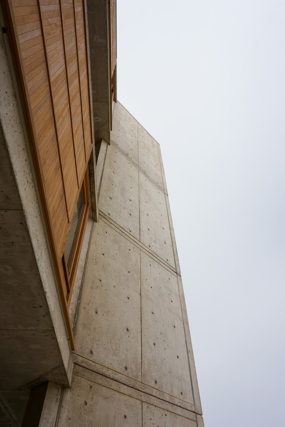 a tall building with a wooden window on the side of it