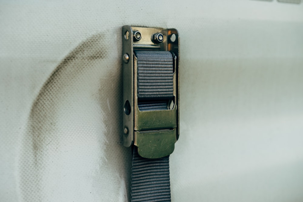 a close up of a metal object on a white surface