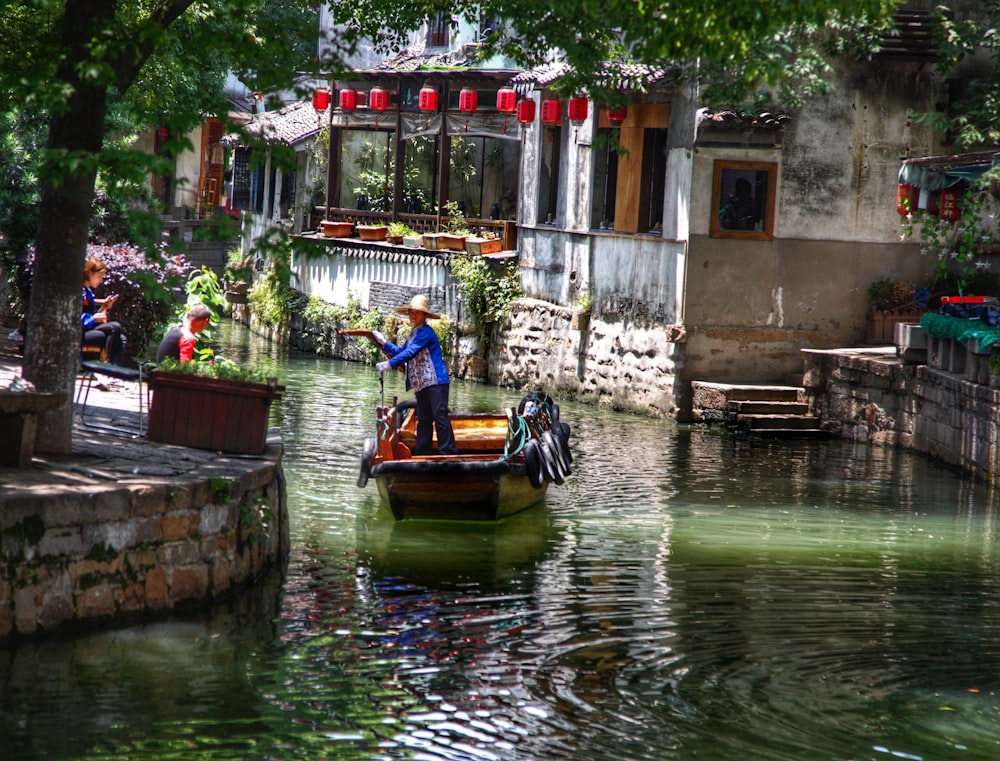 a man on a boat in a canal