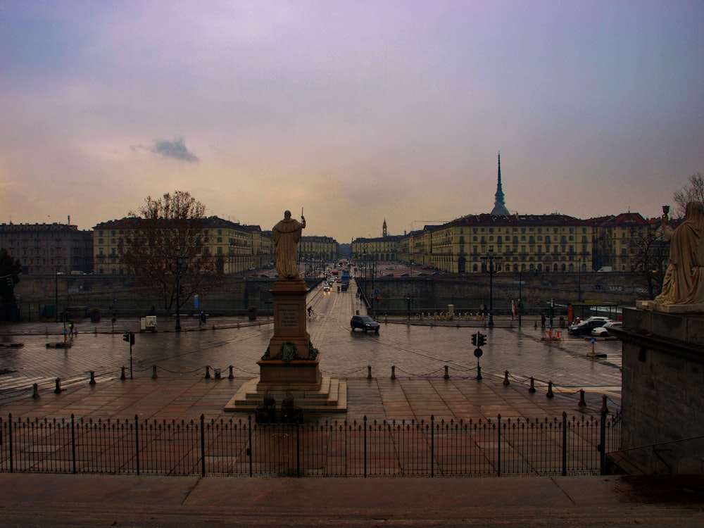 a city square with a statue in the middle of it