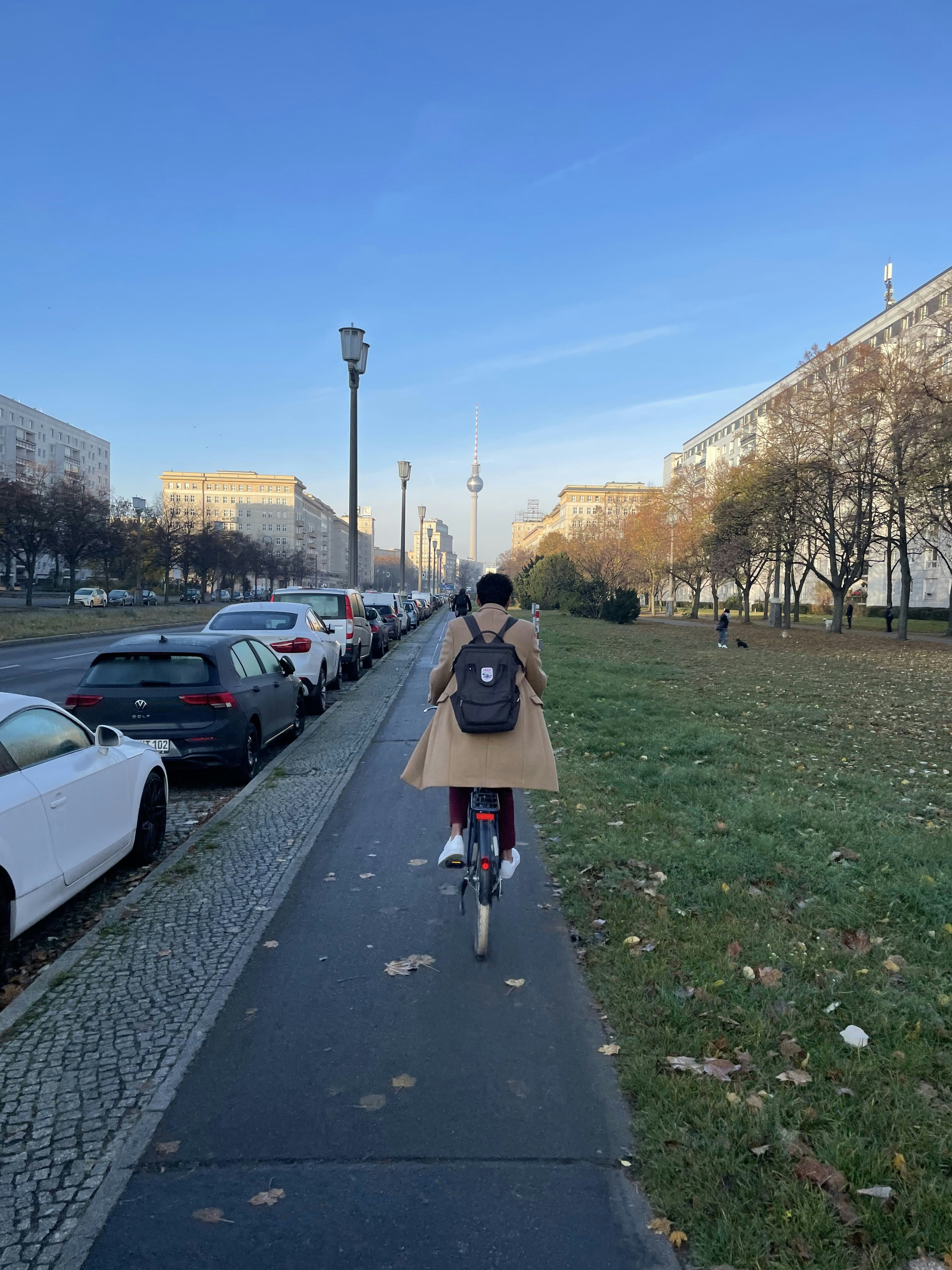 a person riding a bike down a sidewalk