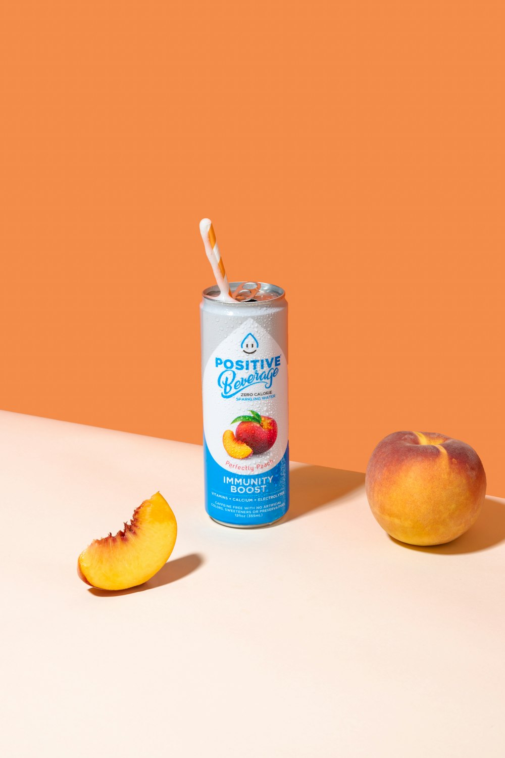 a can of peach juice next to a sliced peach