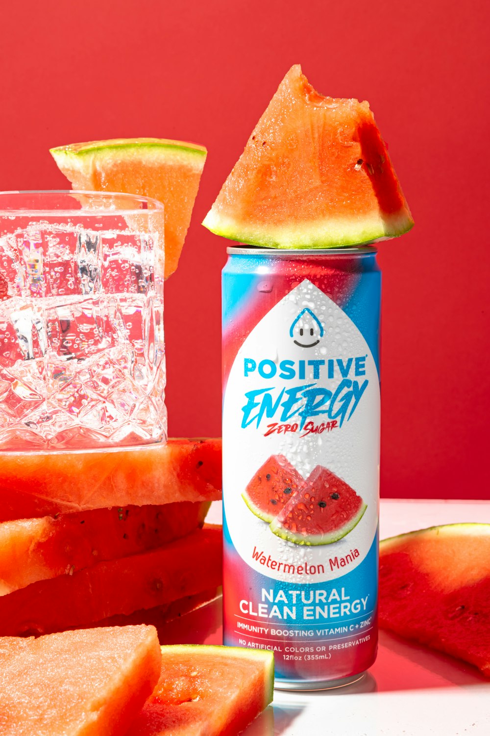 a can of watermelon and slices of watermelon on a table