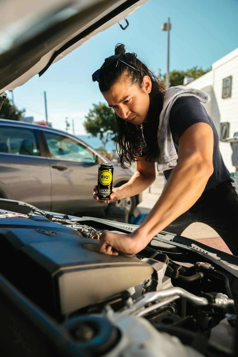 a woman is working on a car engine