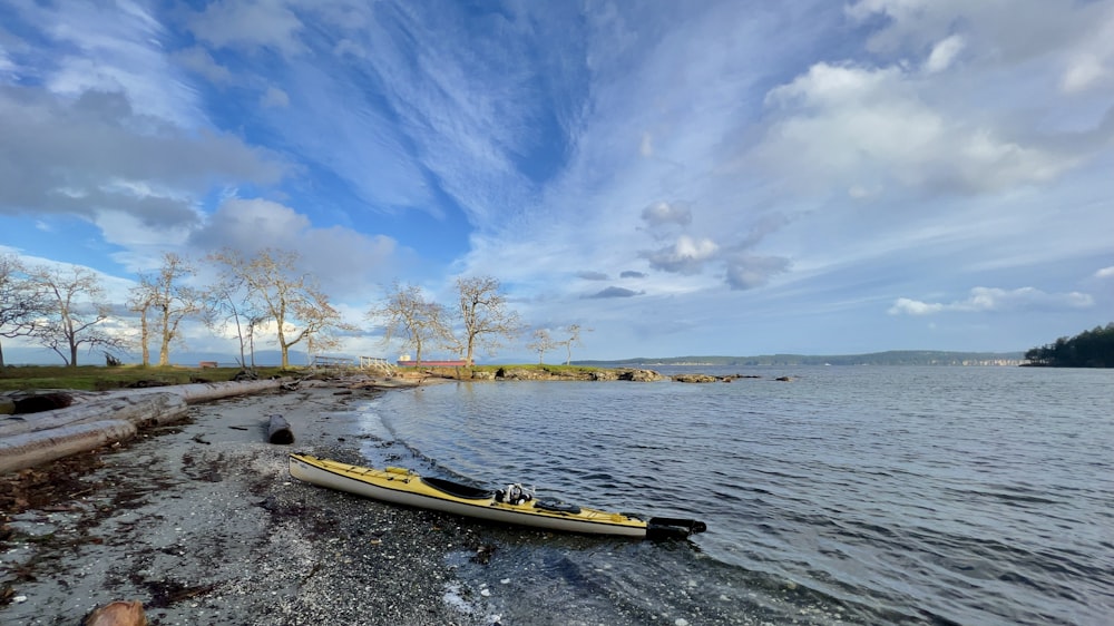 a kayak on the shore of a lake