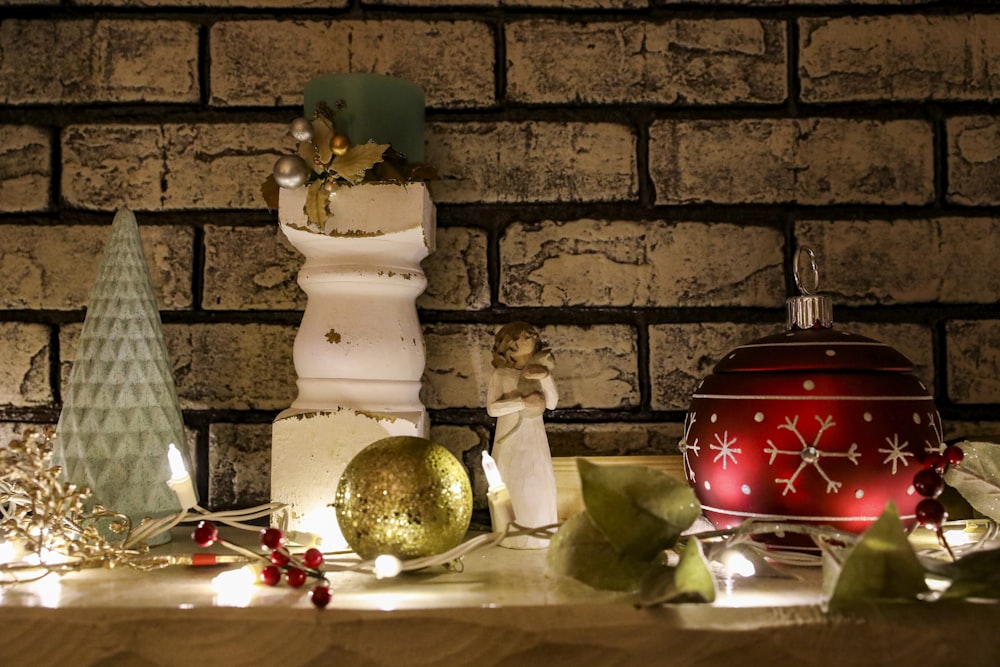 a table topped with christmas decorations next to a brick wall