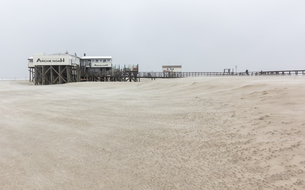 a sandy beach with a building on top of it