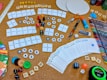 A colorful display of game components including cards and tokens.