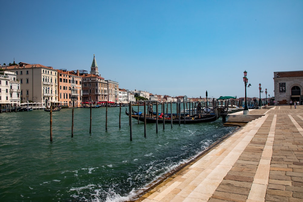 a row of gondolas sitting on the side of a body of water